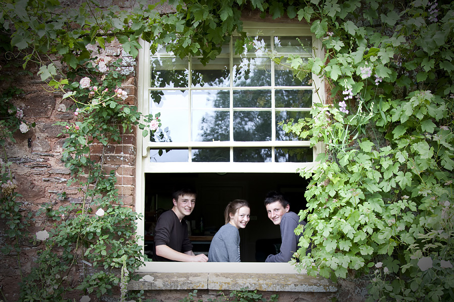 Young adults in a window surrounds by Ivy